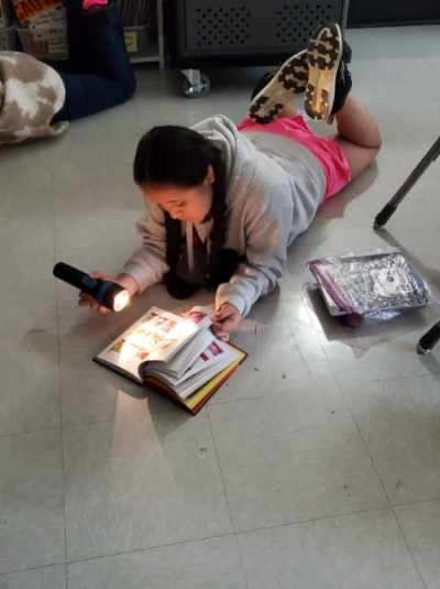 Oliver’s class used flashlights to read on Friday. 