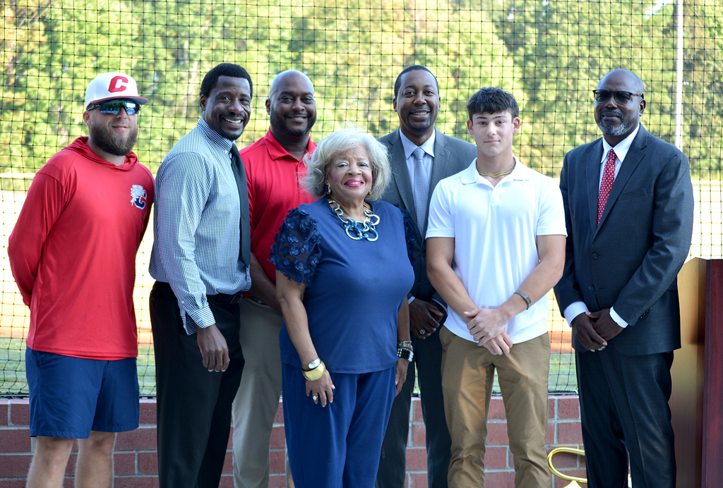 Staff and community members gather to celebrate the opening of the new baseball/softball fields.