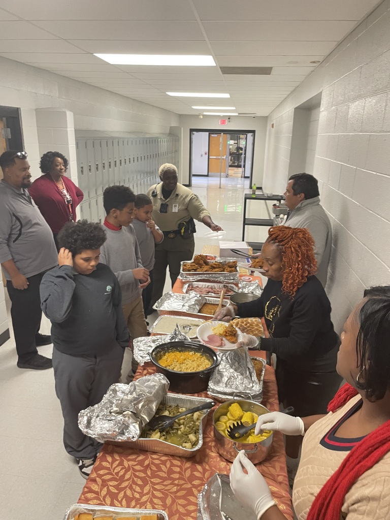 TLC staff serving Thanksgiving meal to students.