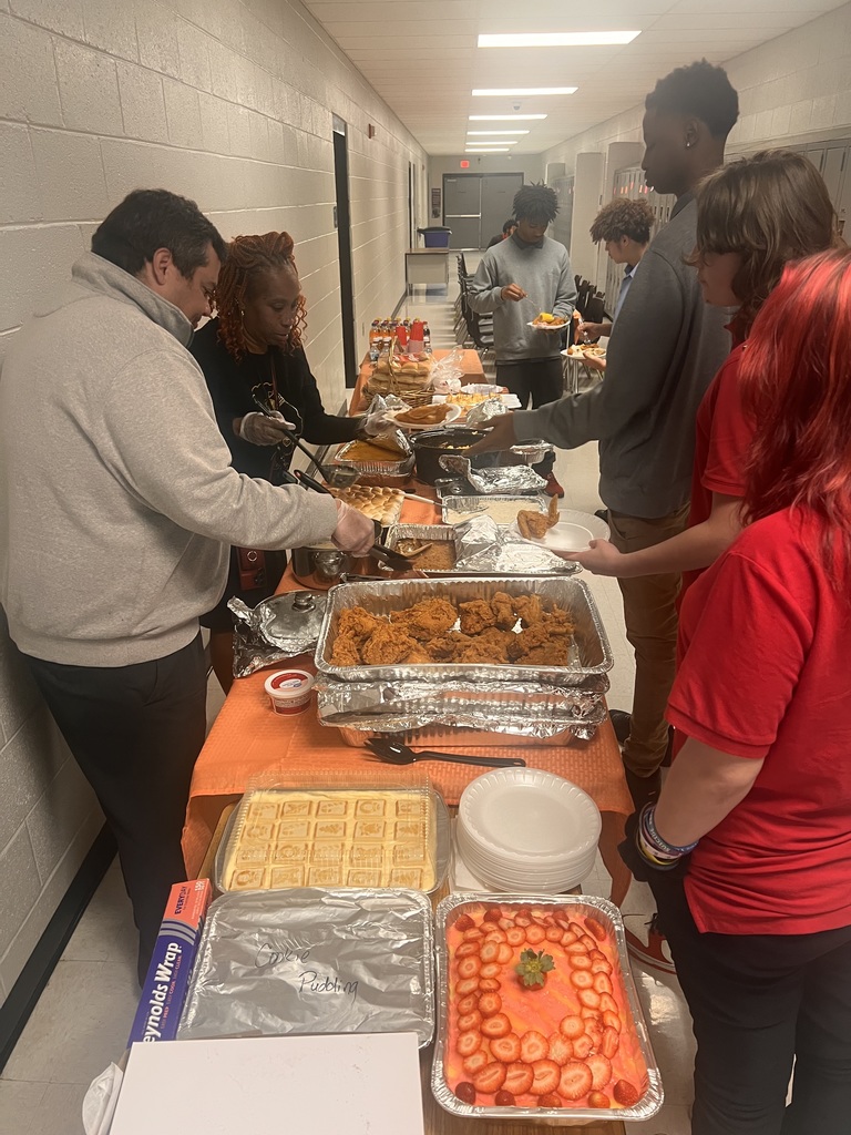 Staff serving Thanksgiving meal to students.