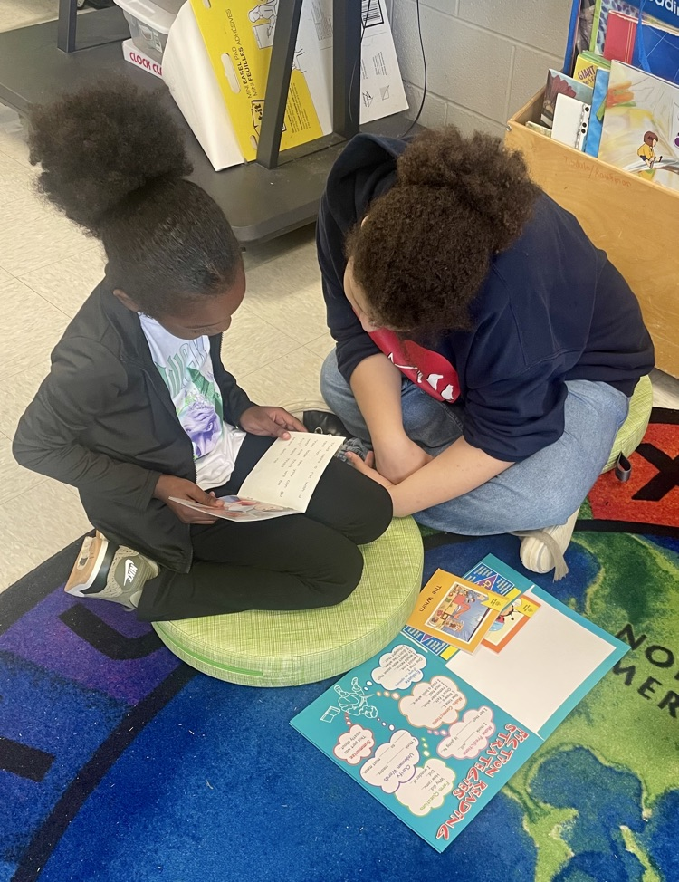 The photo shows book buddies reading together