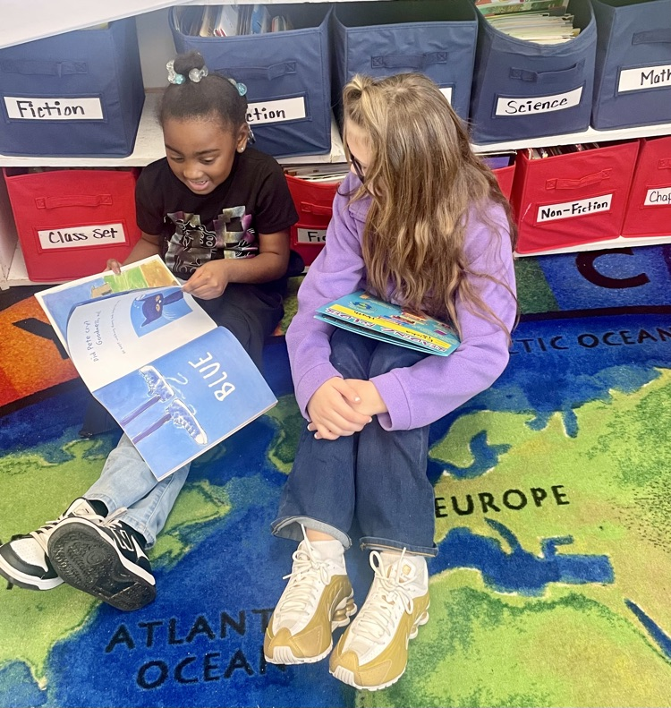 The photo shows book buddies reading together.
