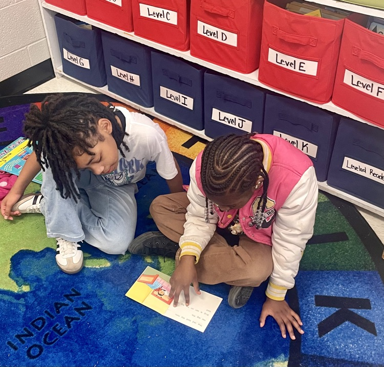 The photo shows book buddies reading together.