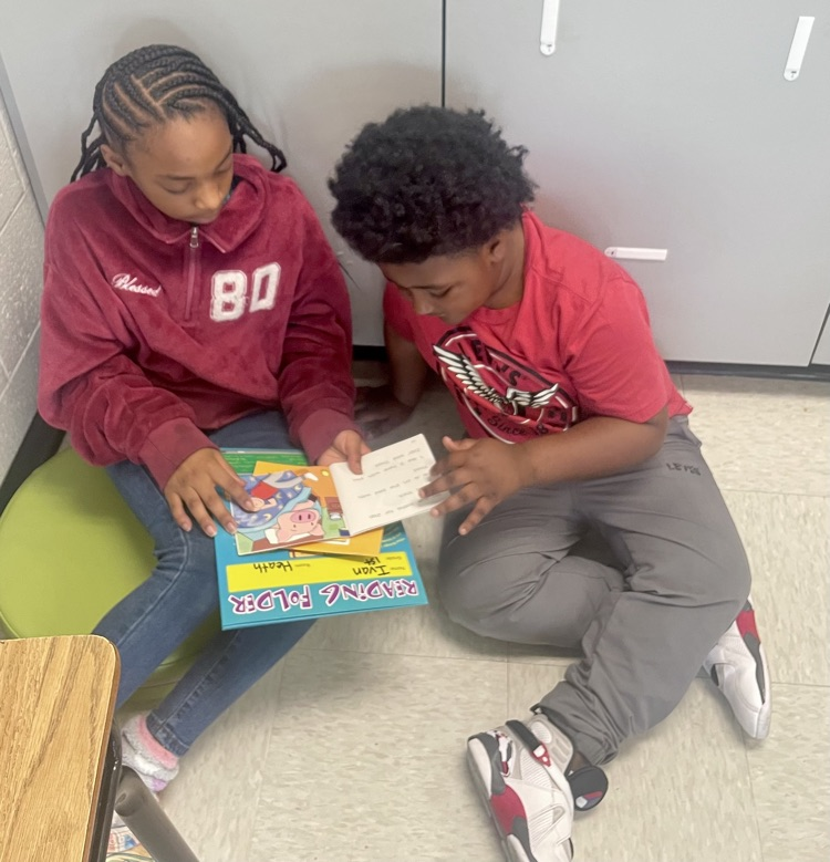 The photo shows book buddies reading together.