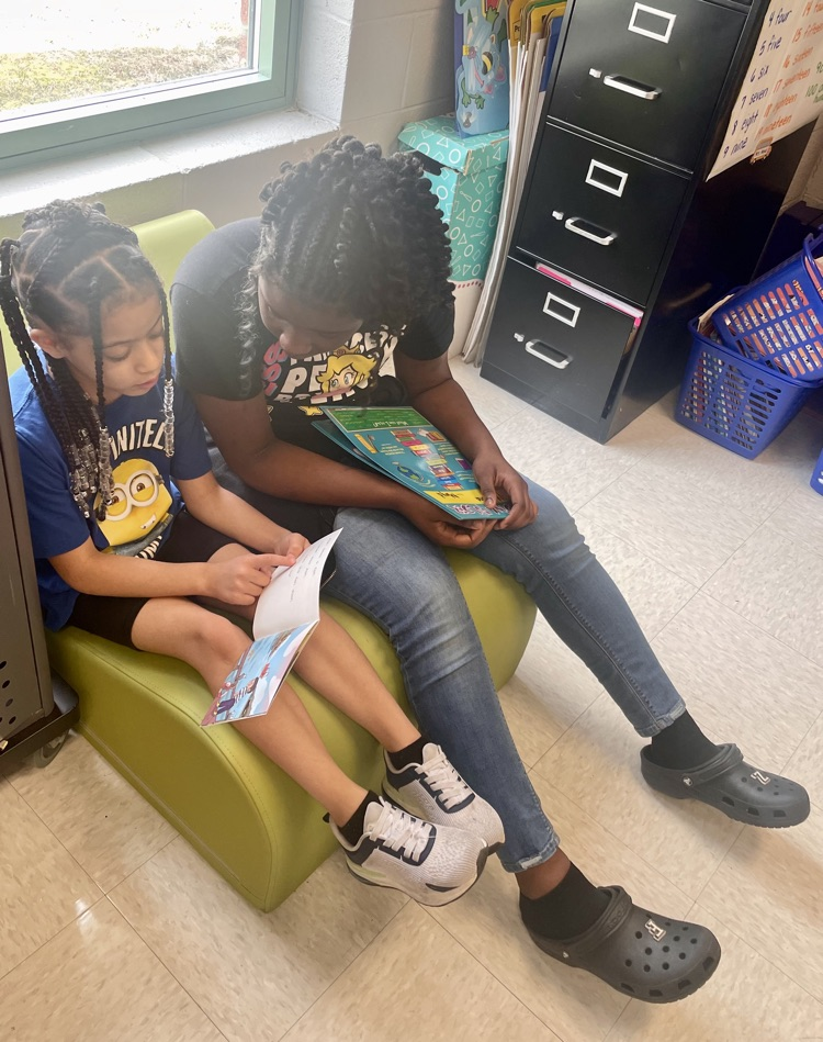 The photo shows book buddies reading together.