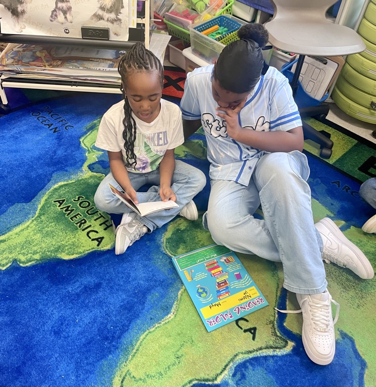 The photo shows book buddies reading together.