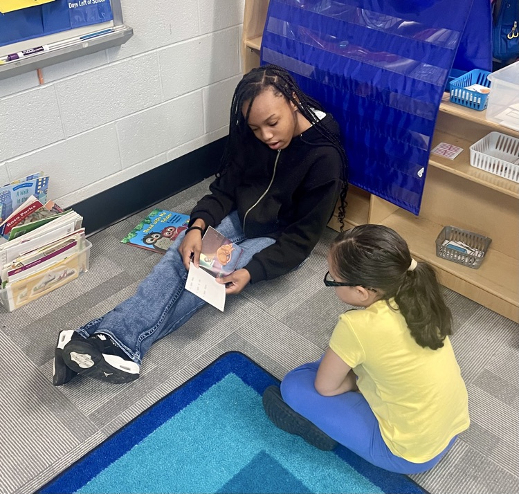 The photo shows book buddies reading together.