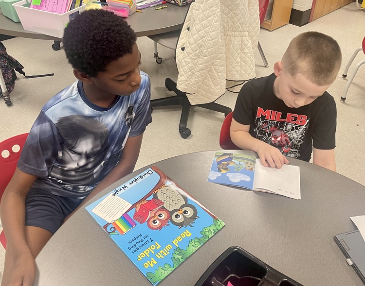 The photo shows book buddies reading together.