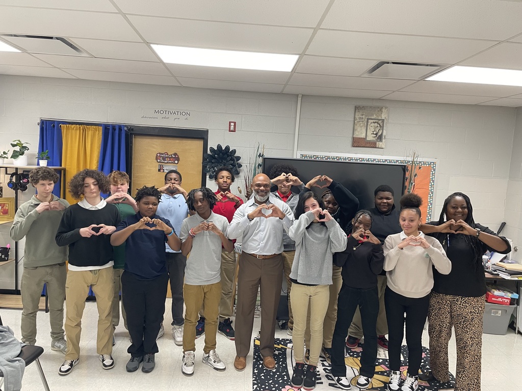 Group picture of Travis Commodore with TLC students and Mrs. Wilson-Young, behavior interventionist.
