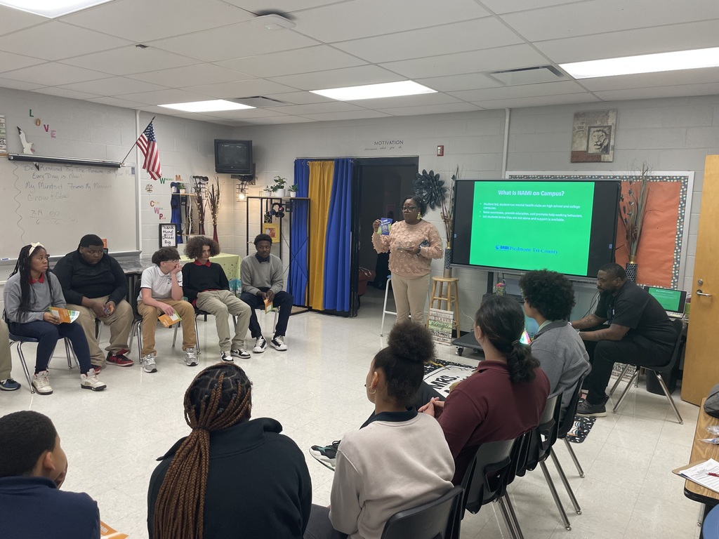 Mrs. Wilson-Young sharing documentation from NAMI with TLC students.