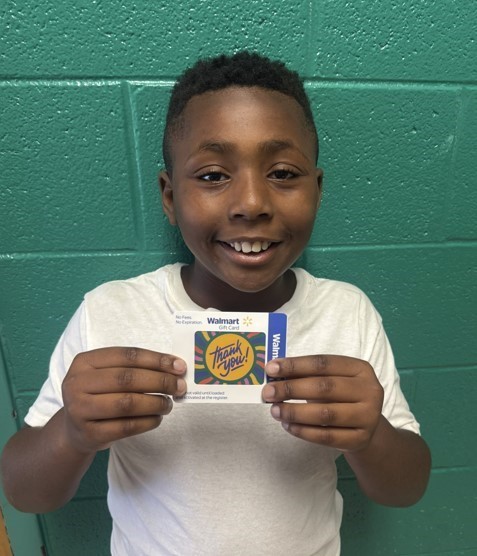 The student pictured won the random drawing for parent surveys.