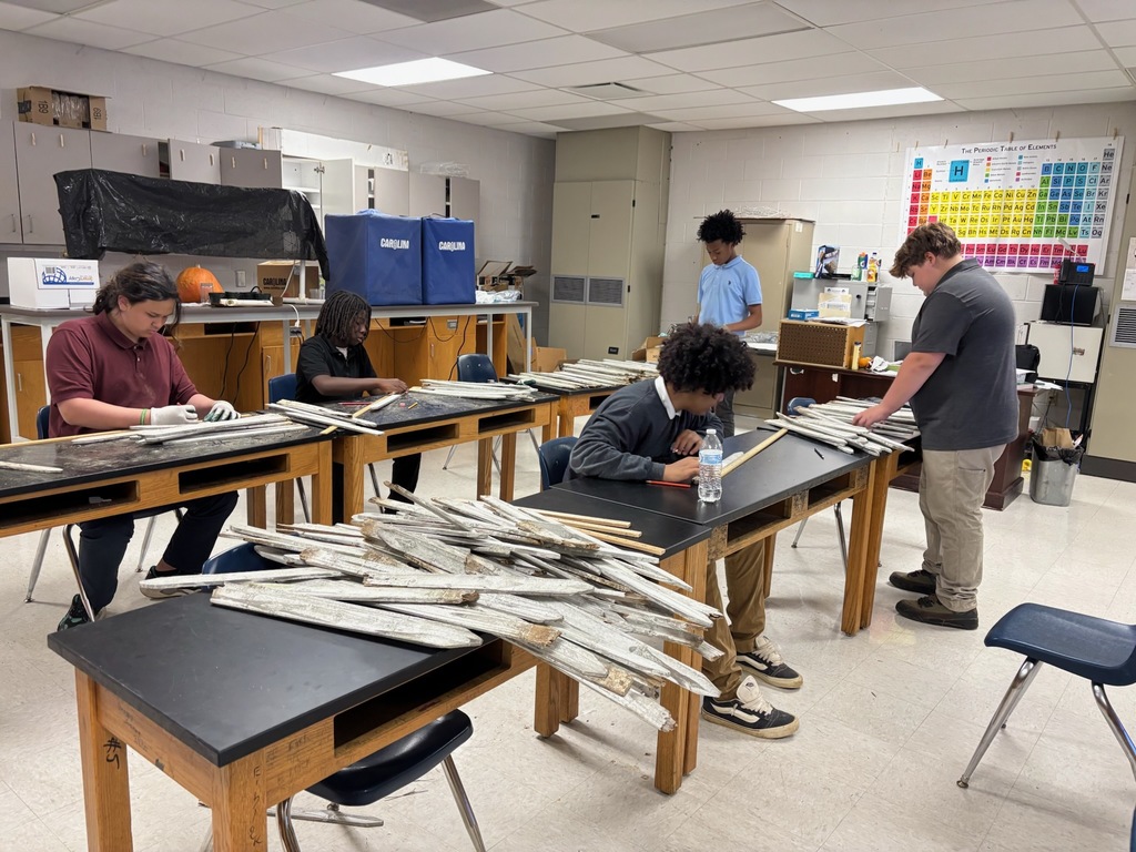 Students measuring pickets for the garden border. 