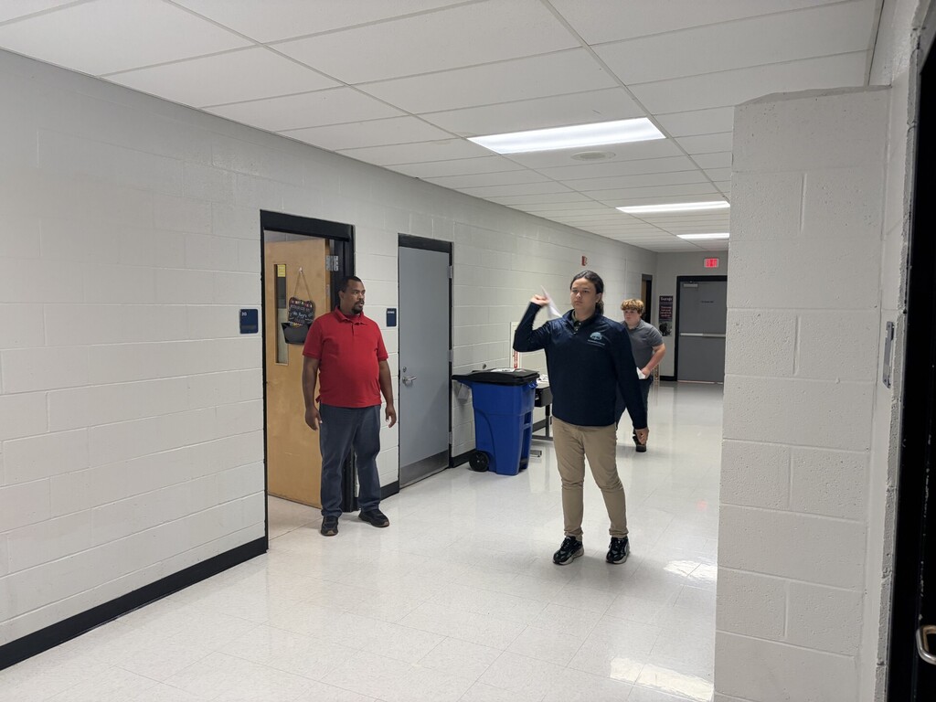 A student preparing to throw his airplane. 