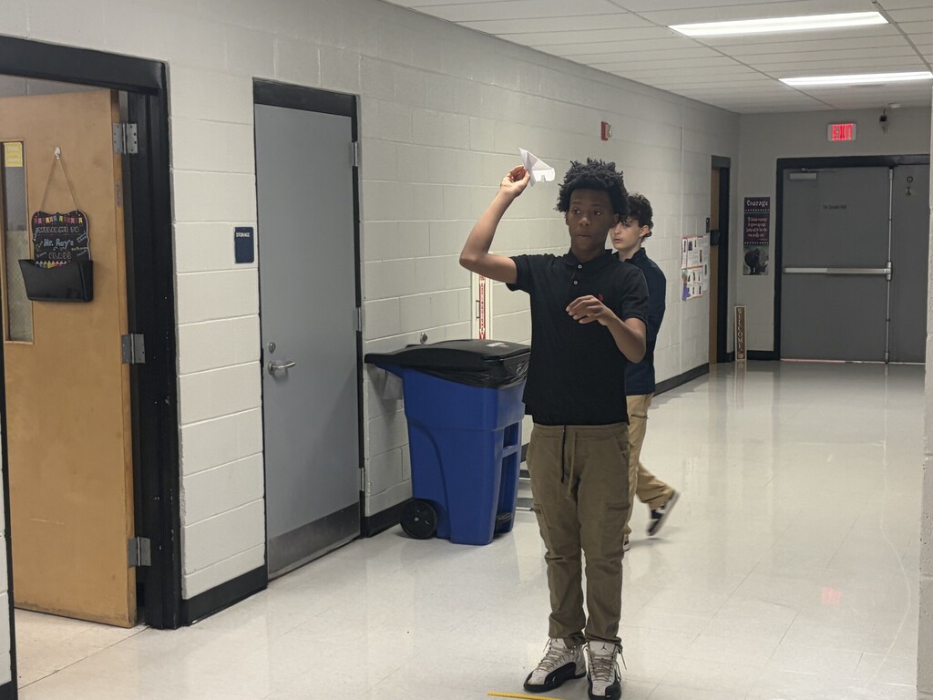 A student preparing to launch his airplane. 