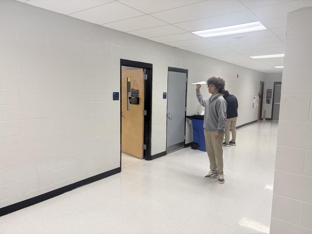 A student preparing to launch his airplane 