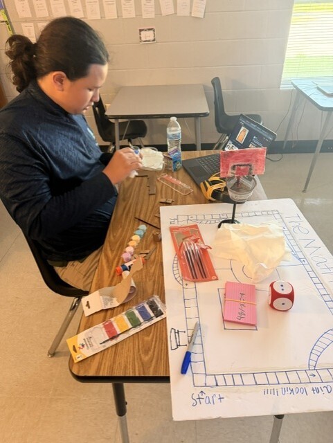 A student working on game board construction. 