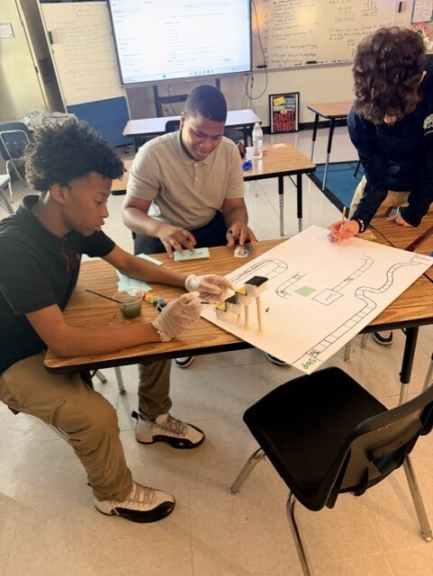Students putting their game board together. 