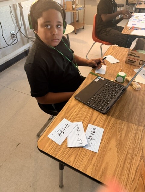 Working on math problems for their game. 