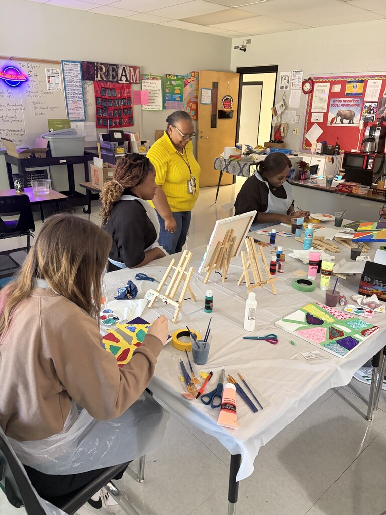 Students using paint and painter's tape to create angles