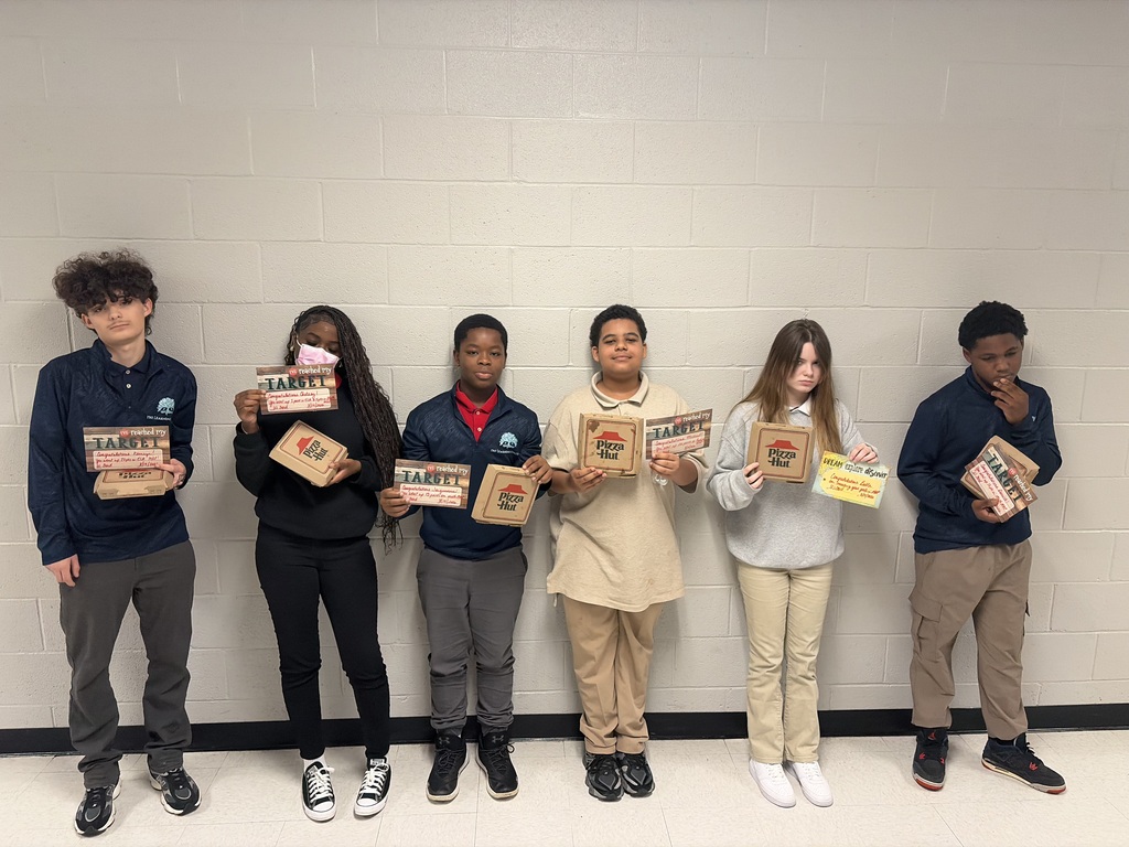 TLC students with gains in their MAP scores shown with their pizzas and certificates for their MAP test scores!
