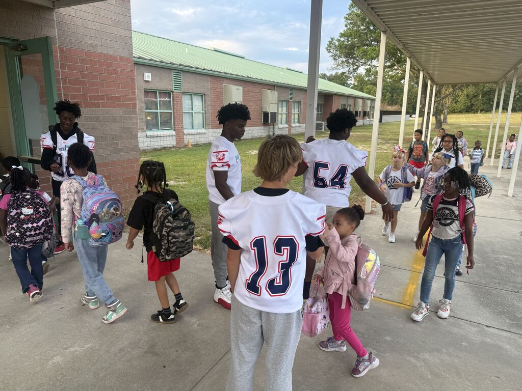 CHS Football players welcomed students to school.