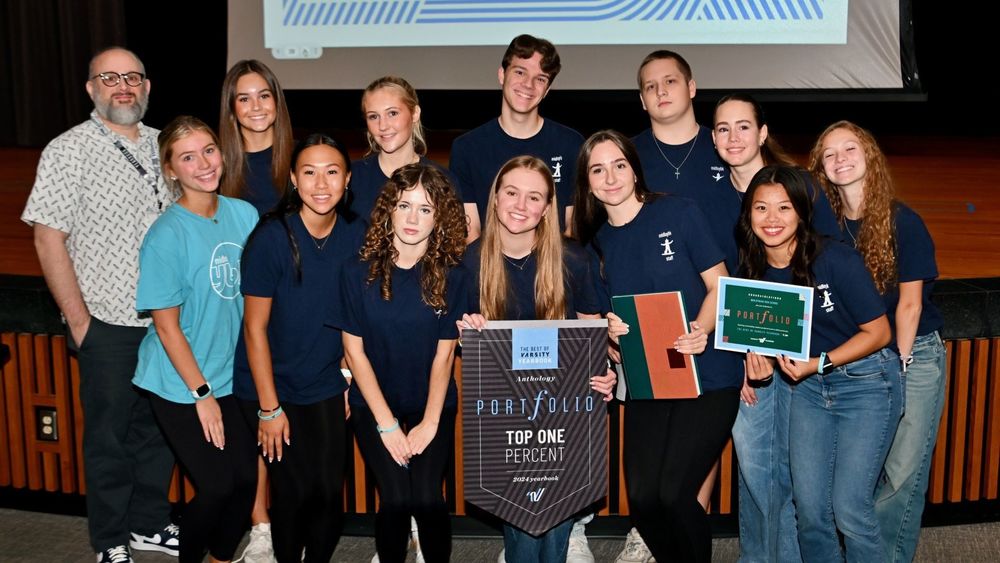Students holding  plaques