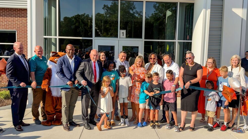 School and county leaders, along with families cut the ribbon on the new school