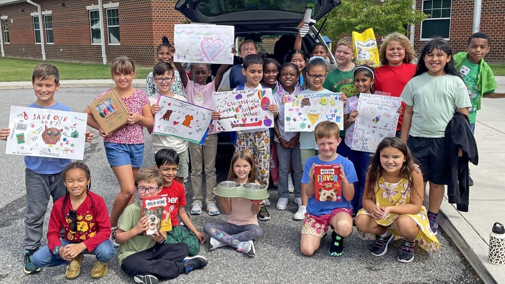 Students holding signs