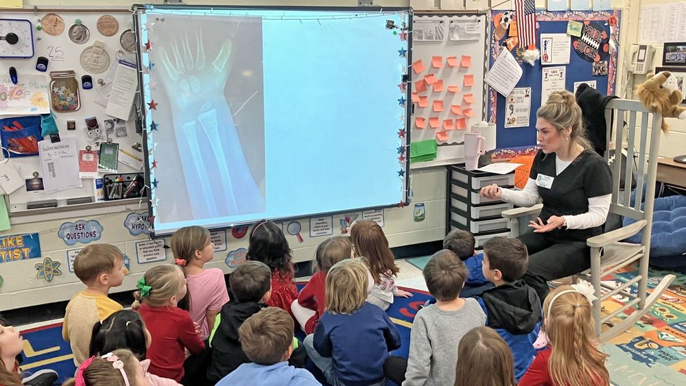 Nurse showing an x-ray to students