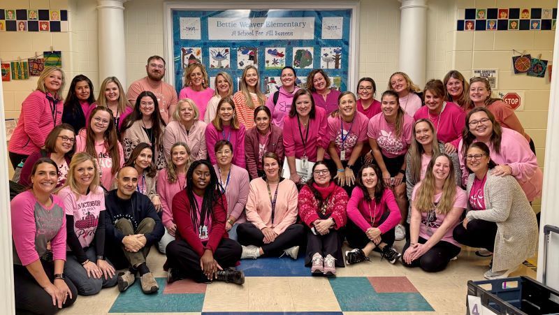 Staff picture with everyone in pink shirts