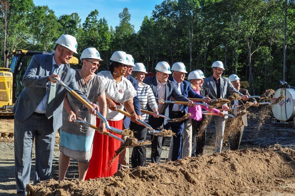 Leaders throwing dirt in groundbreaking