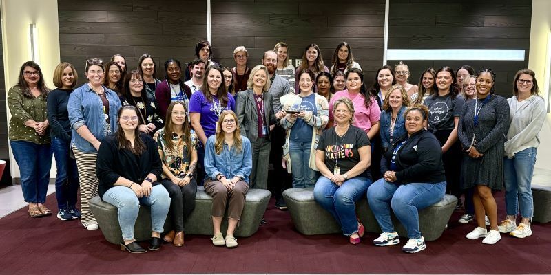 School psychologists group photo with award