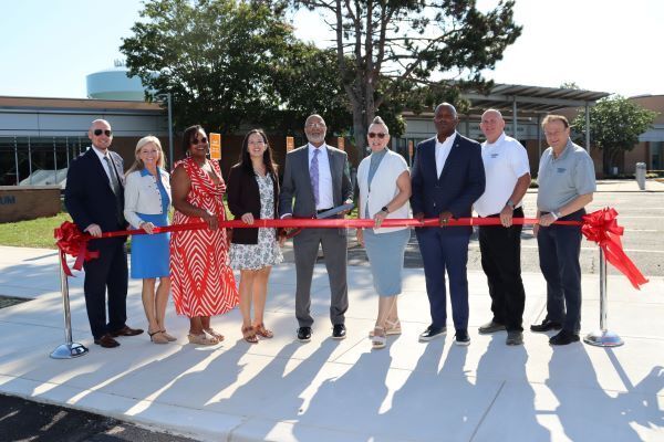 county and school leaders prepare to cut the ribbon