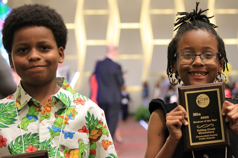 Two students smiling at the camera