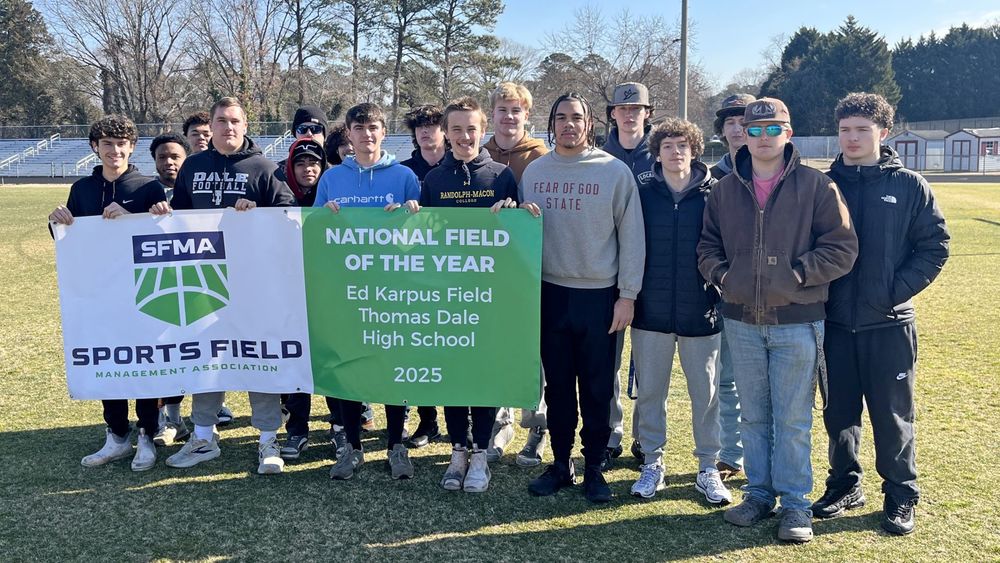 Group holding sign that says "National Field of the Year"