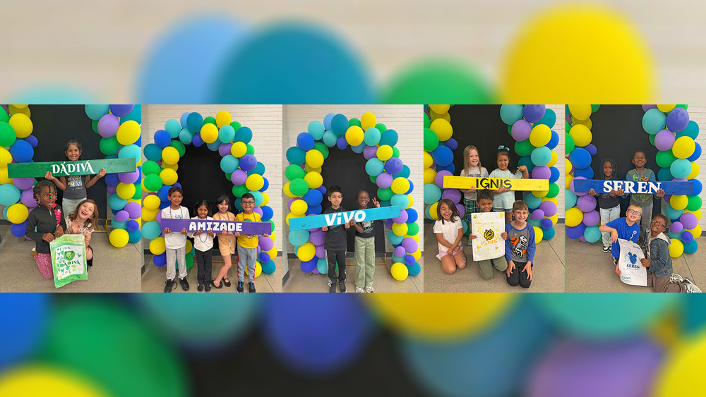 Students posing with their house titles