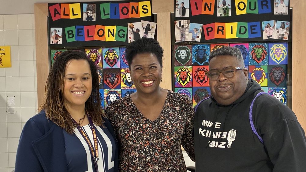 Three people smiling