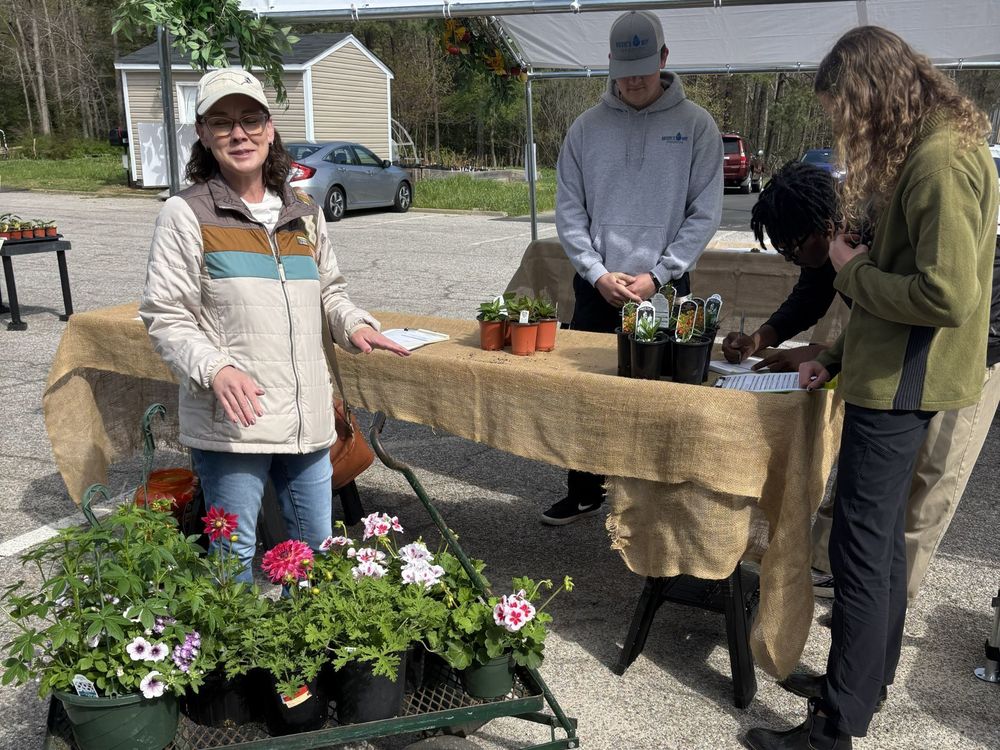 Woman buying a wagon full of plants