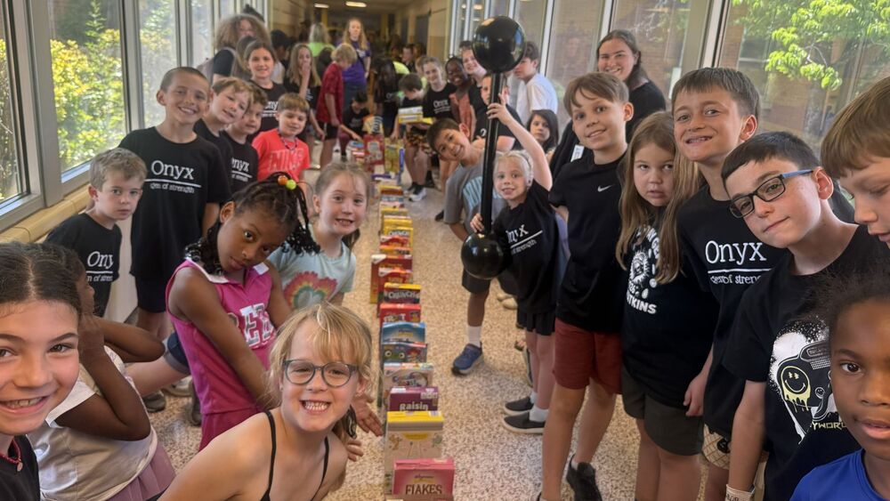 Students crowded around a row of cereal boxes