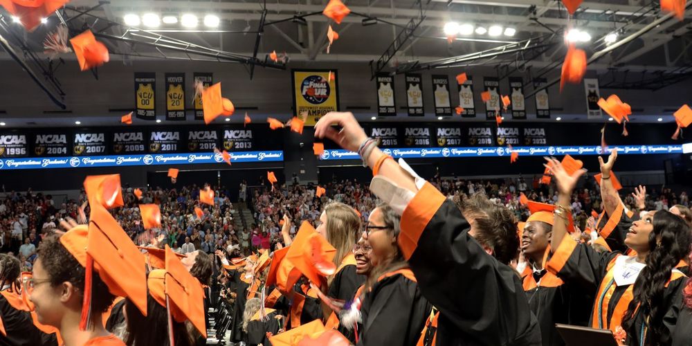 Graduates tossing caps