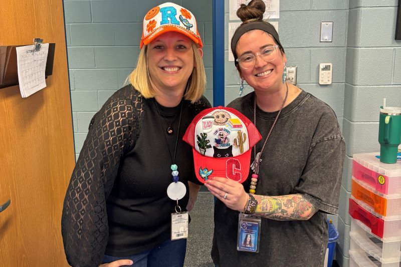 Teachers holding hat