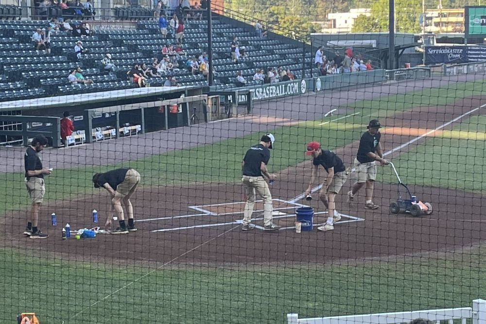 Thomas Dale students working grounds on a baseball field