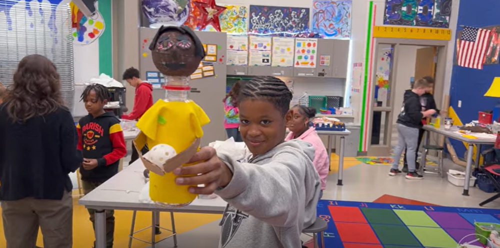 Student shows project to the camera