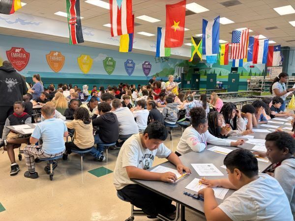 Students at tables working on projects