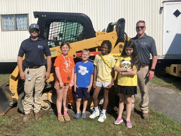 Students in front of a skid steer