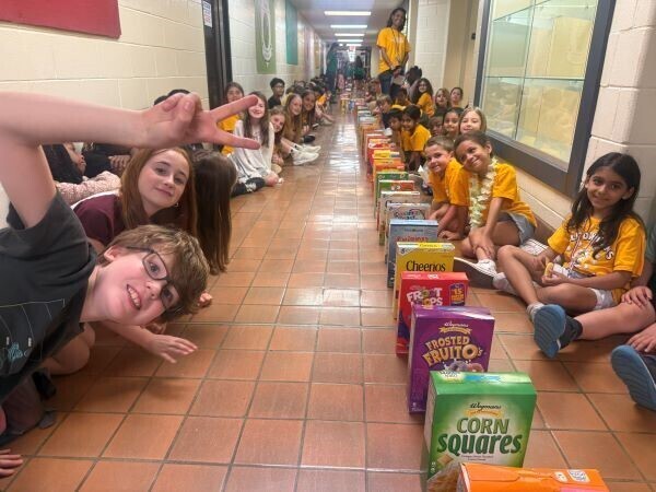Students posing with cereal boxes