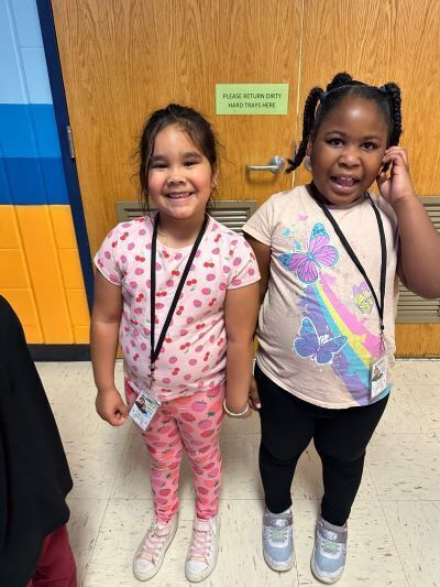 Two young girls smiling at the camera