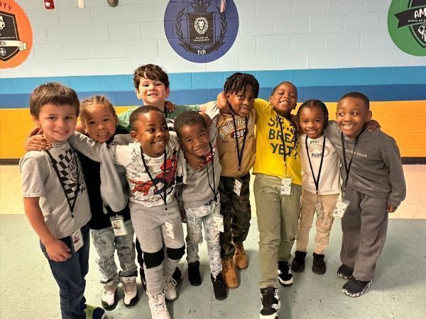 A group of young students laughing and smiling in a group