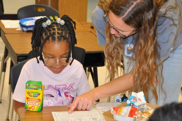 teacher helping student