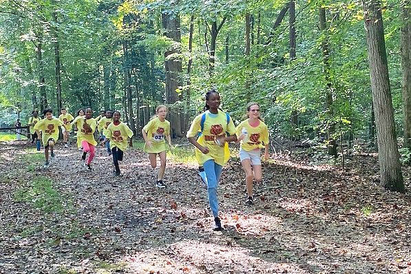 Students running in the woods
